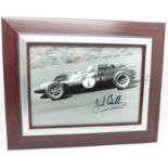 A framed signed photograph of Jack Brabham