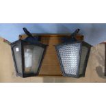 A pair of wall mounted garden lanterns