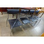 A set of four chrome and faux leather chairs