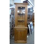 A pine freestanding corner cabinet