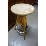 A beech and chrome revolving artist's stool