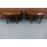 A pair of George III style mahogany and burr walnut demi-lune tables