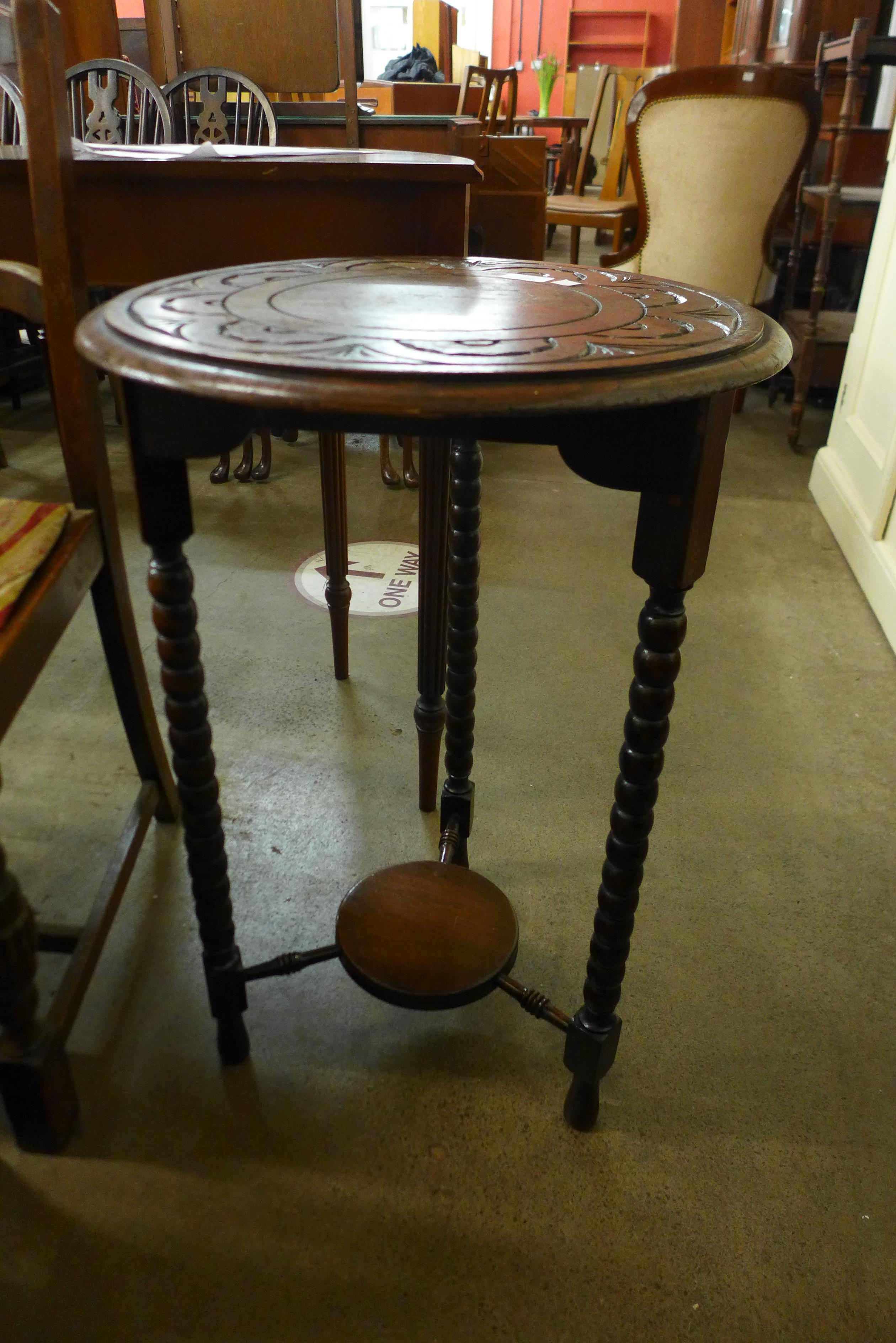 A carved oak circular occasional table