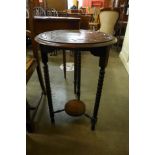 A carved oak circular occasional table