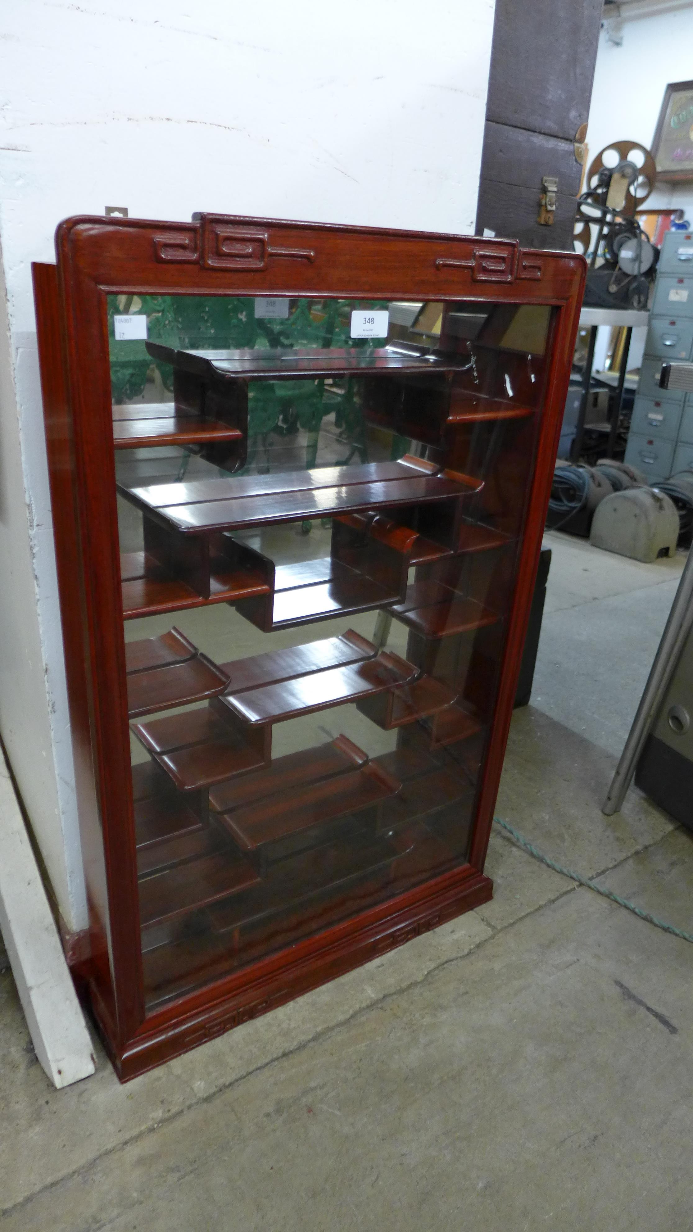 A small Chinese hardwood wall hanging display cabinet