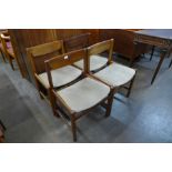 A set of four teak dining chairs