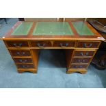 A yew wood pedestal desk