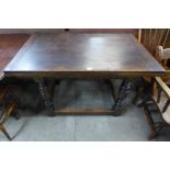 A 17th Century style oak draw-leaf refectory table