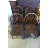 A set of four oak wheelback kitchen chairs