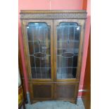 An oak four door bookcase (lacking shelves)