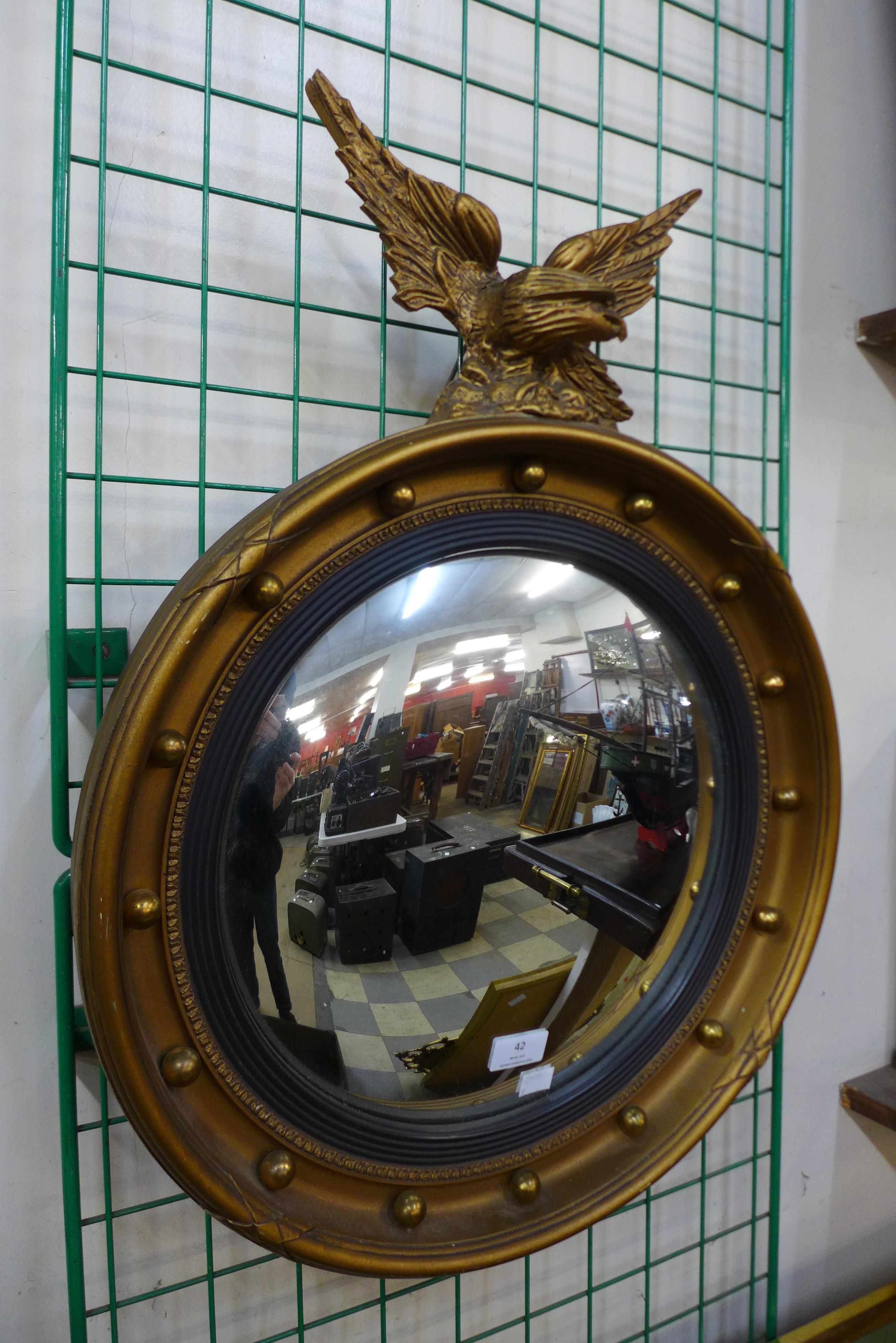 A Regency style gilt framed convex mirror, 66cms h