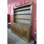 A Victorian Aesthetic Movement oak library bookcase, 234cms h, 184cms w, 42cms d