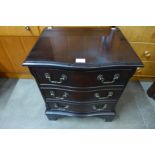 A small mahogany serpentine chest of drawers