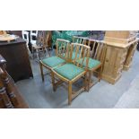 A set of four Ercol oak dining chairs