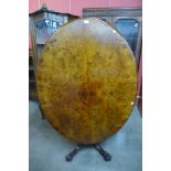 A Victorian burr walnut oval tilt-top breakfast table, 69cms h, 136cms l, 102cms w