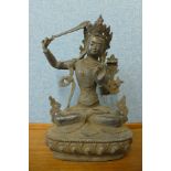 An oriental bronzed figure of a seated deity, 33cms h