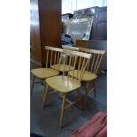A set of four beech stickback kitchen chairs