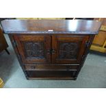 A carved oak credence cupboard