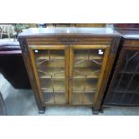 A carved oak two door bookcase