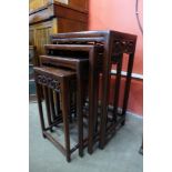 A Chinese carved hardwood nest of quartetto tables, 67cms h