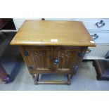 A small oak two door cupboard