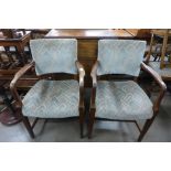 A pair of 1930's oak and upholstered fireside chairs