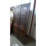 A George III oak freestanding corner cupboard