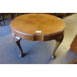 A walnut circular coffee table