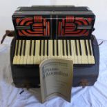 A Hohner Tango V accordion and case