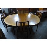 A Nathan teak extending dining table and four chairs