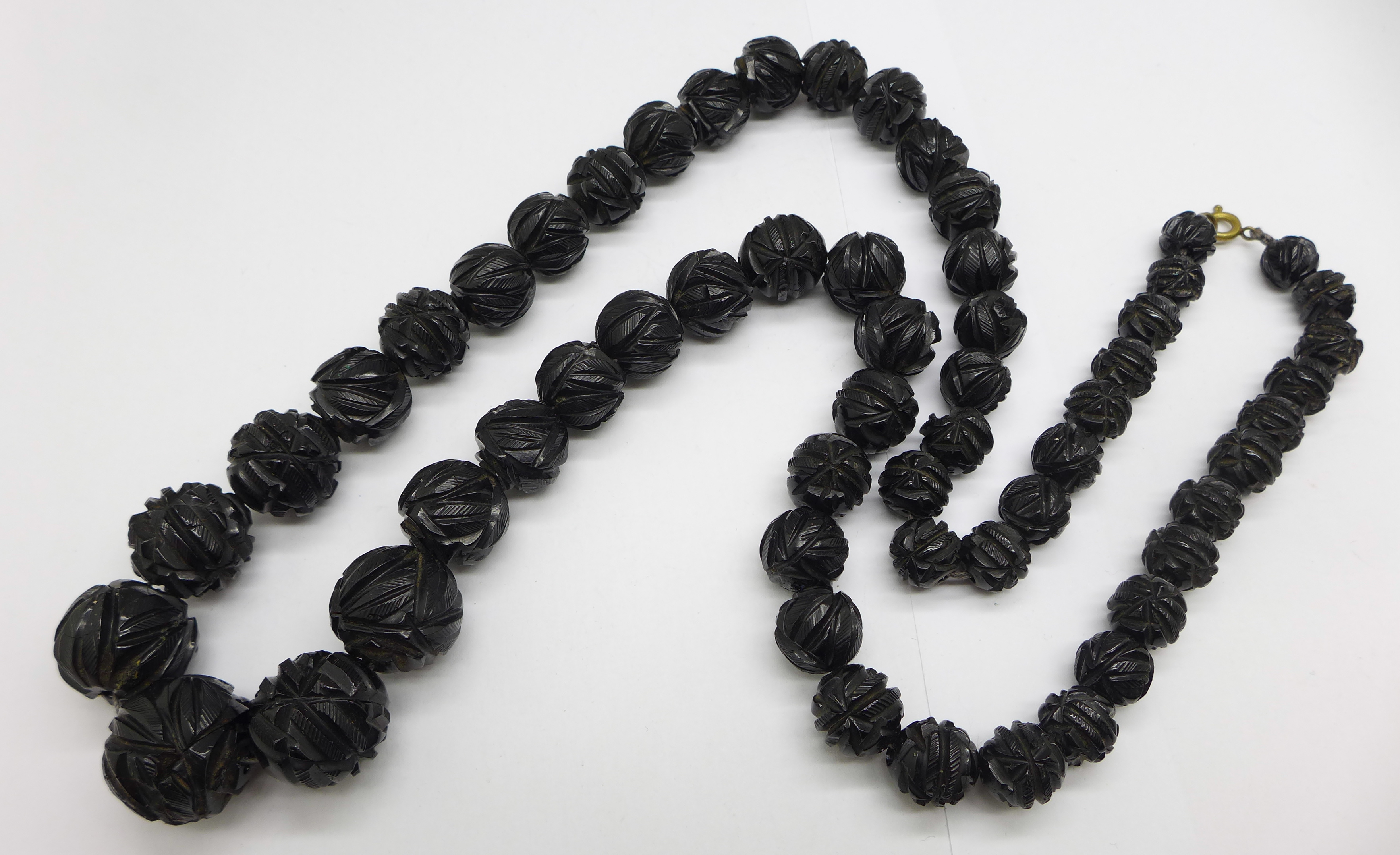 A carved Whitby jet bead necklace, 71cm