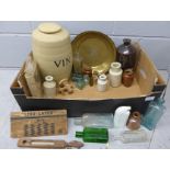 A stoneware wine barrel, other stoneware bottles, a glass Boots Chemist bottle, other glass bottles,