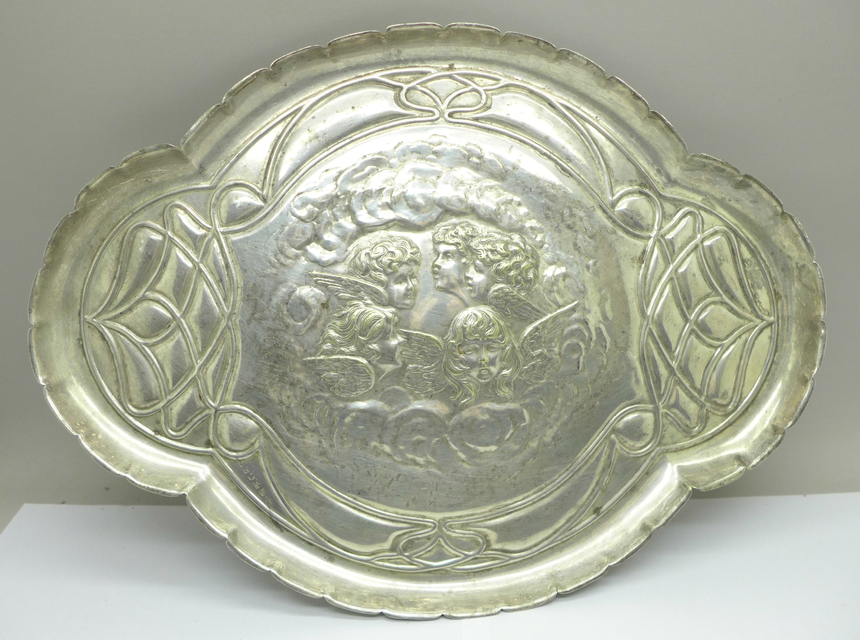 A plated dressing table tray with Reynolds angels, marked J.C. & Co. Ltd., 30cm