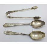 A pair of Victorian silver bright cut sugar bows and two silver bright cut spoons, 40.7g