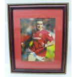 A framed signed photograph of Manchester United legend Eric Cantona