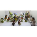 A collection of twenty bird figures including Beswick and a novelty penguin salt and pepper pair, (