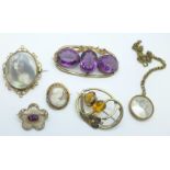 Three Victorian pinchbeck brooches including one large purple stone set and one photograph brooch, a