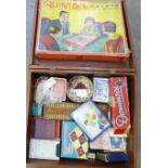 A collection of games and playing cards, in a wooden box