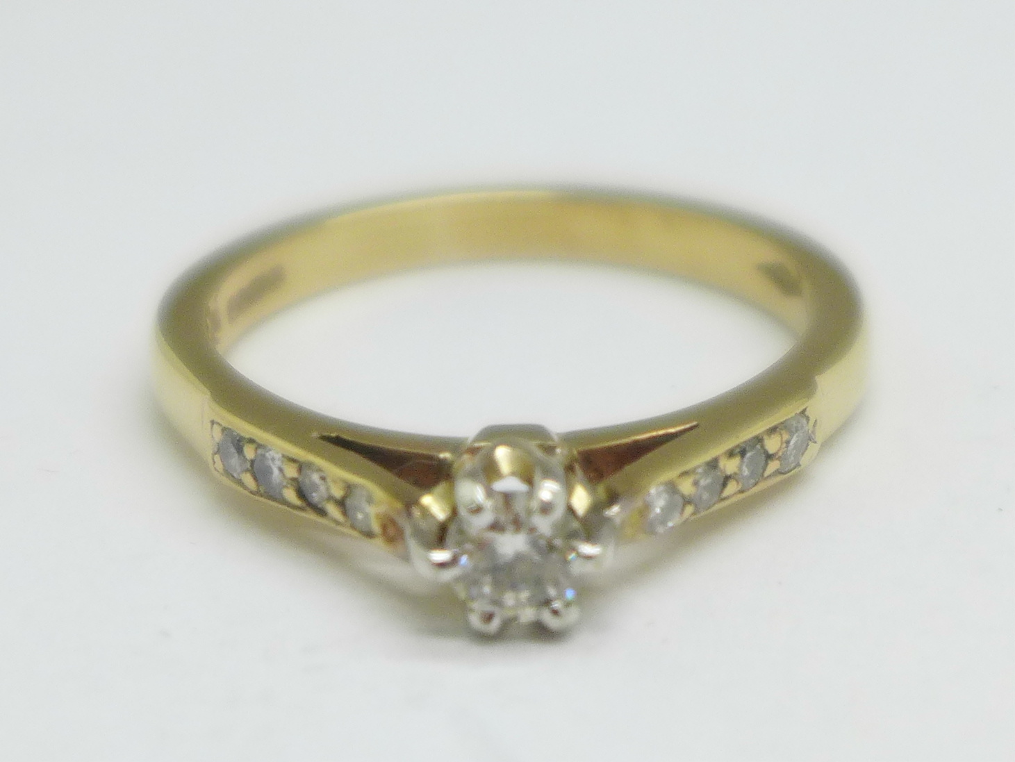 A 9ct gold and nine stone diamond ring, 3g, P, main stone approximately 0.25carat weight