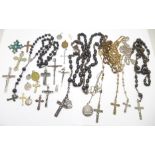 A collection of rosaries, crucifix and cross pendants, religious medallions and charms