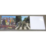 Three Beatles LP records, The White Album, Abbey Road and Sgt. Pepper's Lonely Hearts Club Band, one