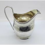 A George III silver jug, London 1805, with monogram, 110g