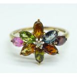 A 9ct gold multi coloured gem-set ring, including tourmalines with a small diamond centre stone, 2.