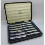 Six silver handled tea knives, cased