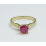 A yellow metal and ruby solitaire ring, marked 750, 3.1g, L
