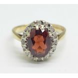 A 9ct gold, garnet and white sapphire cluster ring, 3.4g, O
