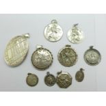 Two silver lockets and a collection of silver St. Christopher pendants, (large locket fastener