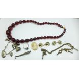 A faceted bead necklace, hunting theme cufflinks, a charm bracelet, etc.