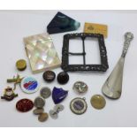 A mother of pearl card case, a large buckle, bachelor buttons, badges, shoe horn, a pair of