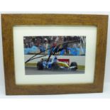 A framed signed photograph of Fernando Alonso